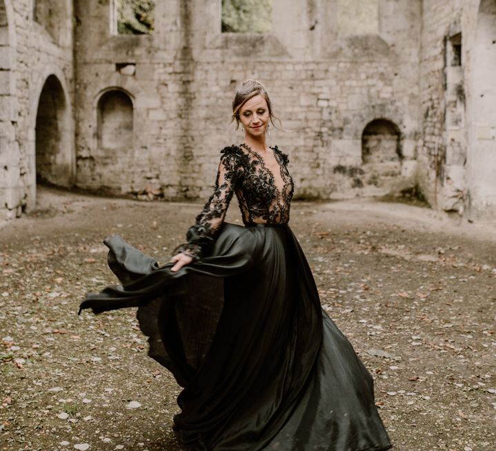 Bride in a black wedding dress with full skirt and fitted lace bodice 