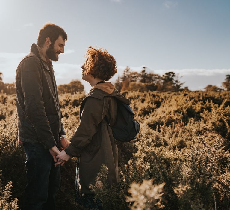 Couple stand together outdoors during golden hour in Dartmouth 