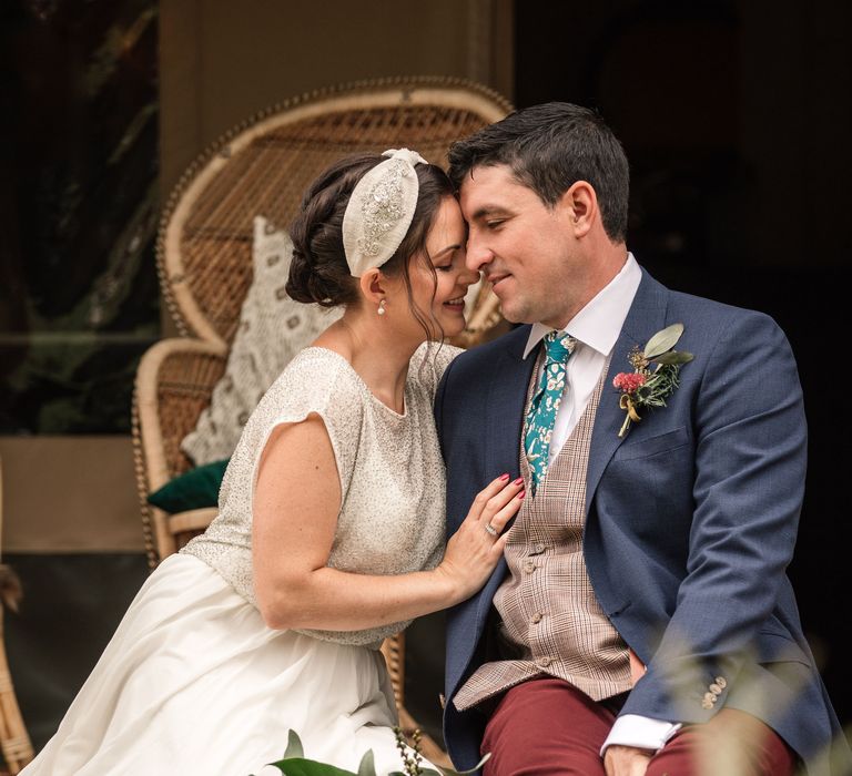 Bride & groom kiss whilst sat together in safari inspired shoot