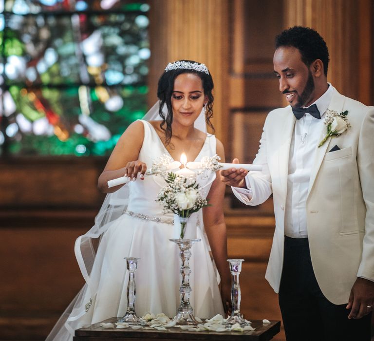 Ethiopian bride and groom lighting the candle at their Christian church wedding 