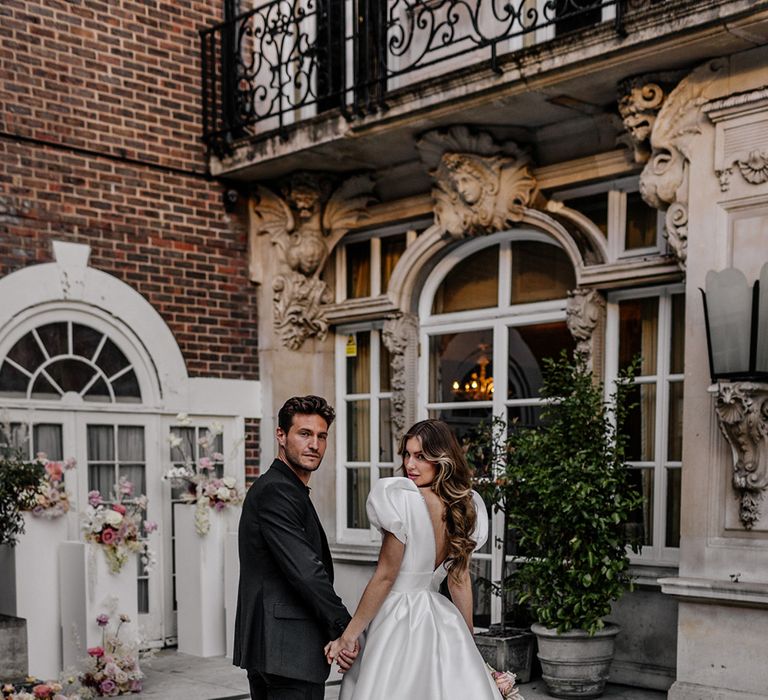 Luxury wedding with bride in a princess wedding dress with puff sleeves, low back and long train