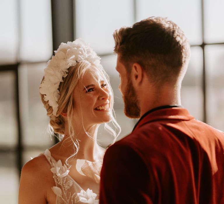 Smiley bride in a white fabric flower appliqué headband 