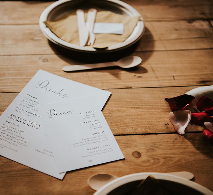 A simple dinner and drinks menu rests on a table at a wedding breakfast.