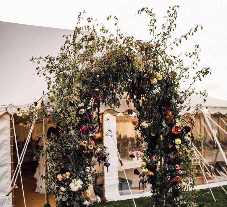 Foliage wedding arch at marquee wedding