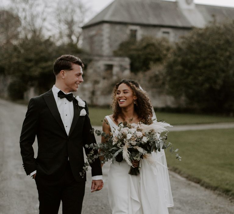 Bride & groom walk together during winter wedding outdoors