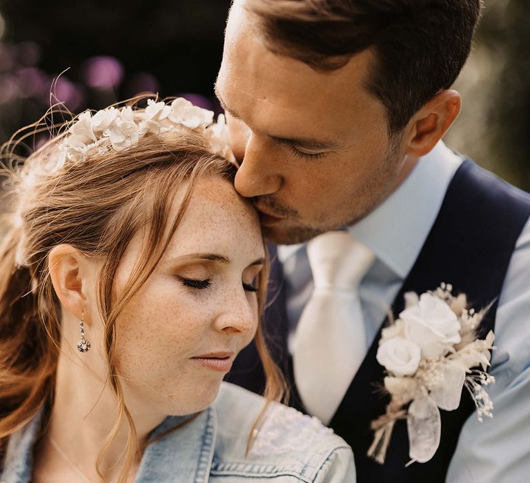 Bride leans into her groom on her wedding day