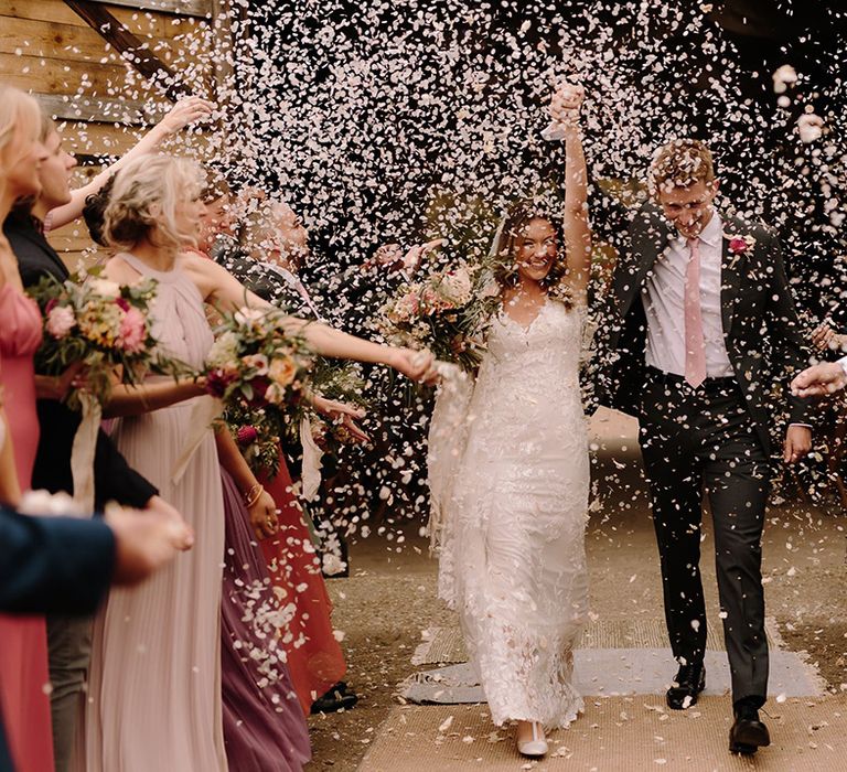 Confetti moment for bride and groom at White Pond Farm wedding venue