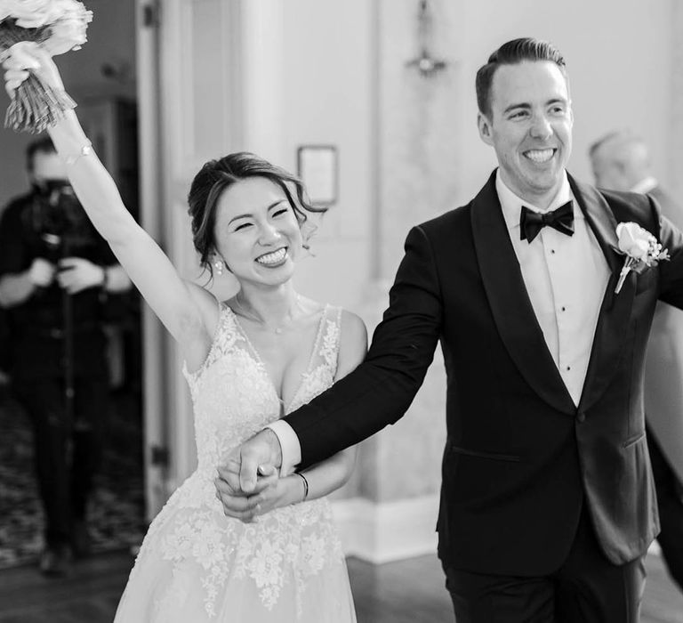 Bride & groom celebrate in black & white image after wedding ceremony