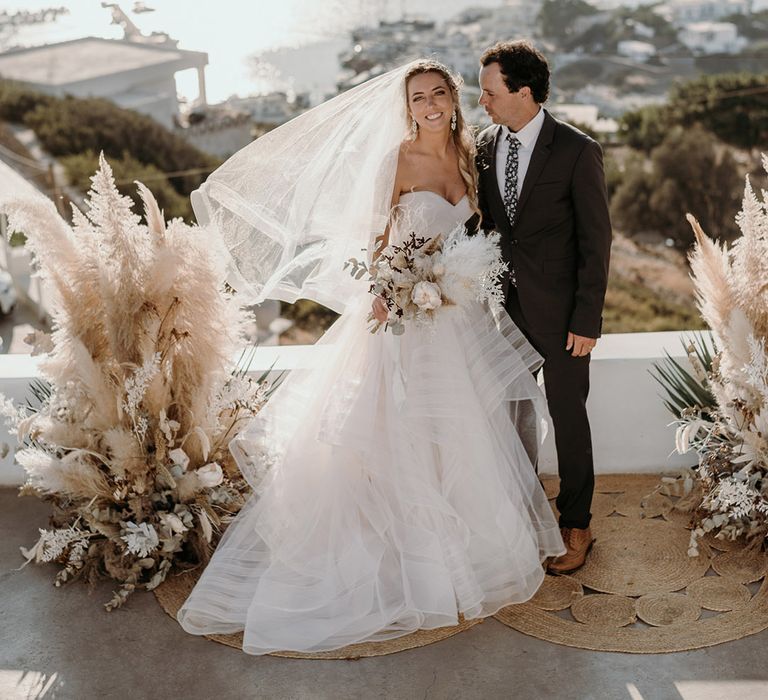 Bride & groom look lovingly at one another on their wedding day