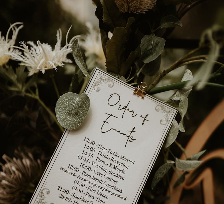 Order Of Service stationery surrounded by green foliage 