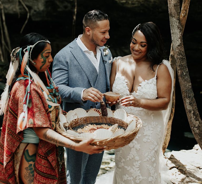 Bride and groom take part in traditional customs in Mayan wedding ceremony for destination wedding 