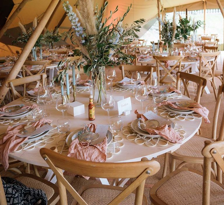 Table setting in Buffalo Tipi reception area with pastel pink and blue theme and large gypsophila cloud 