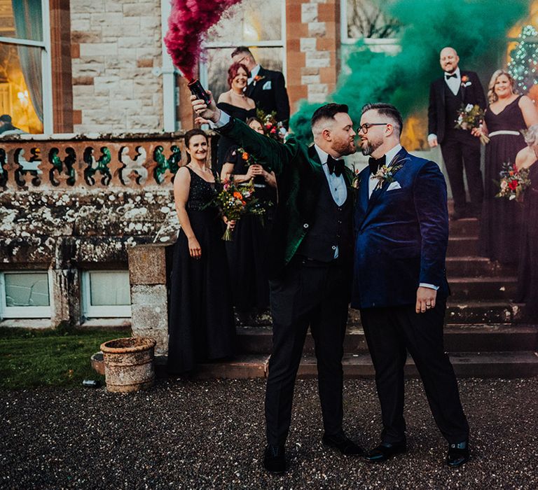 Grooms, bridesmaids and other guests have a smoke bomb photoshoot outside Castle Leslie Estate wedding