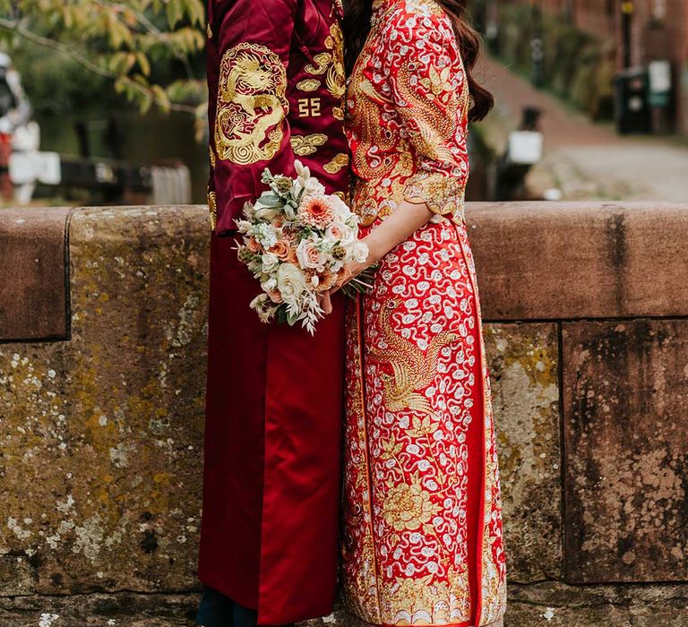 Striking red and gold Chinese wedding attire for multicultural wedding in Manchester city centre