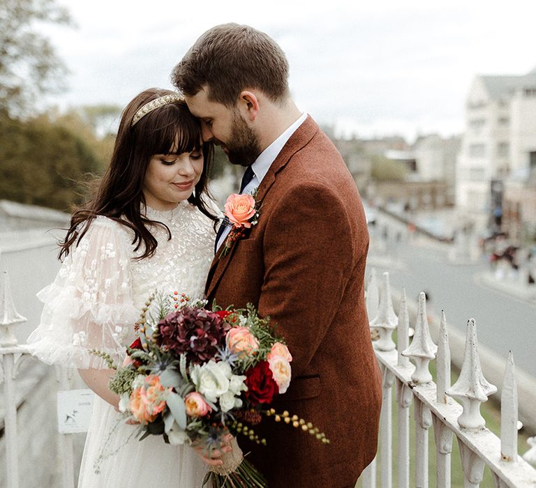 Groom hugs the bride after their autumnal wedding in York 