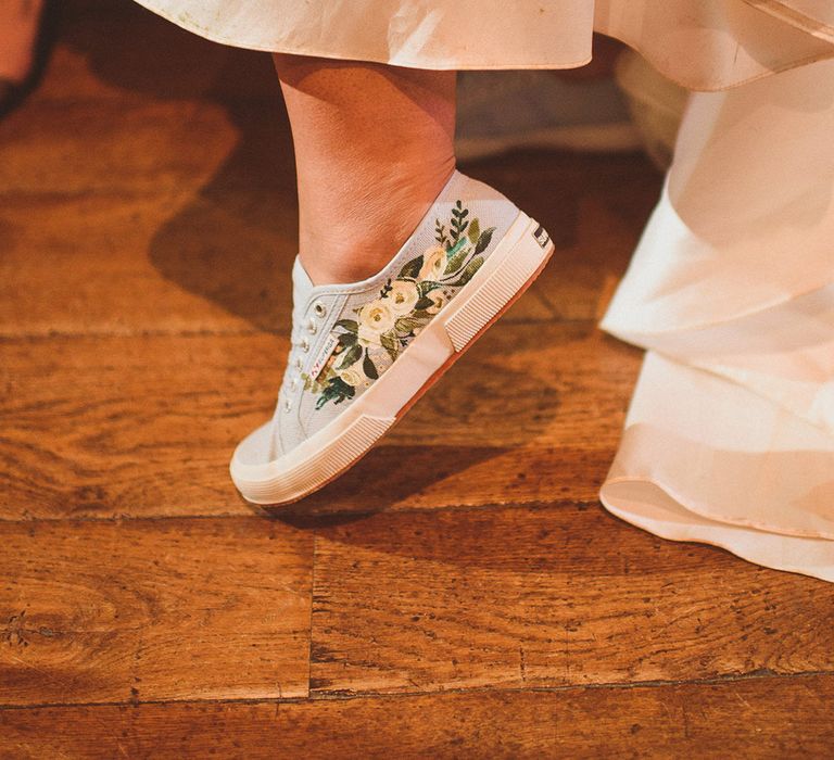 Bride wears handpainted custom shoes for her wedding evening 