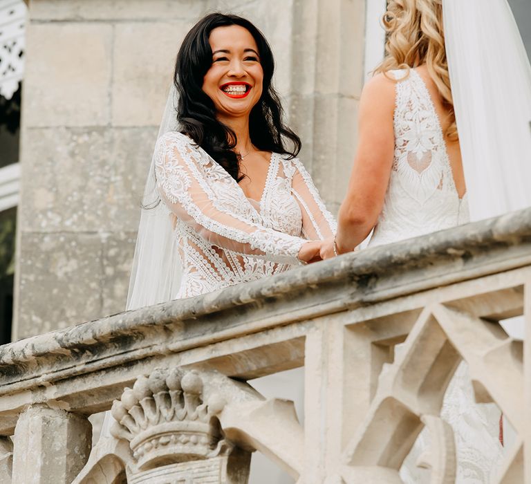 Bride smiles widely as they hold hands together during the ceremony 