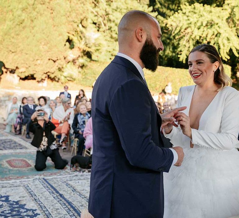 Bride & groom marry outdoors in Florence Italy as bride wears V-neck gown with slicked back blonde hair 