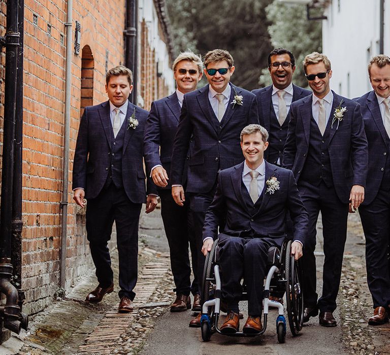 Groom with the groomsmen in blue suits and gold ties for the Henley Brewery wedding 