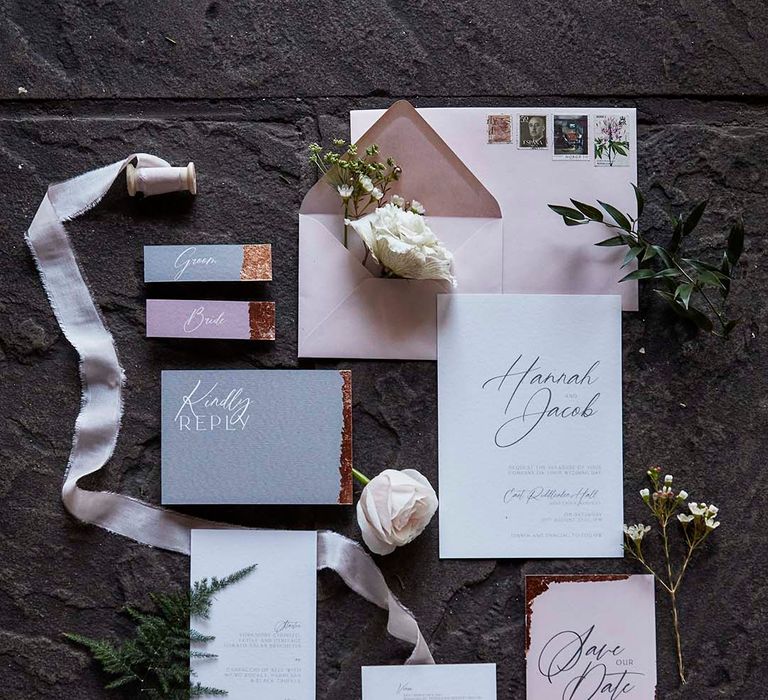 flat lay or pink, grey and white wedding stationery suite 