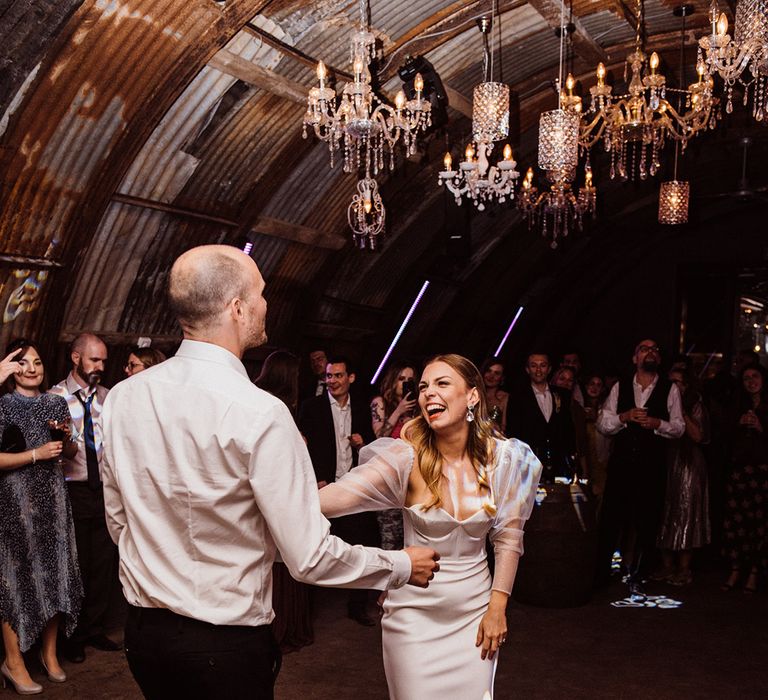 Bride in her second wedding outfit with organza sleeves dances with the groom 