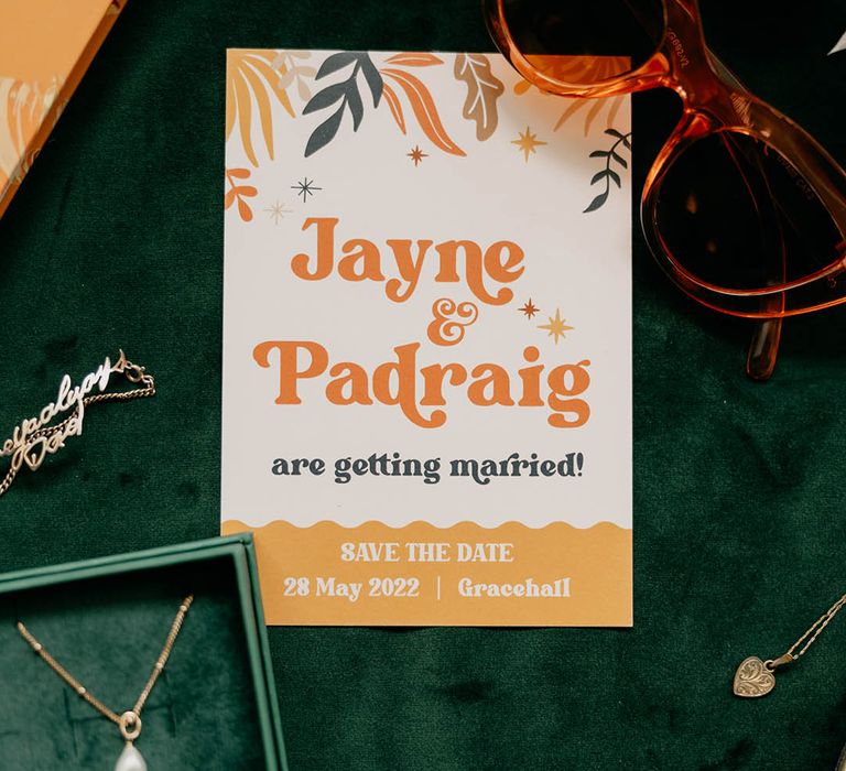 Save the date wedding stationery with orange, yellow and green floral design for retro wedding 