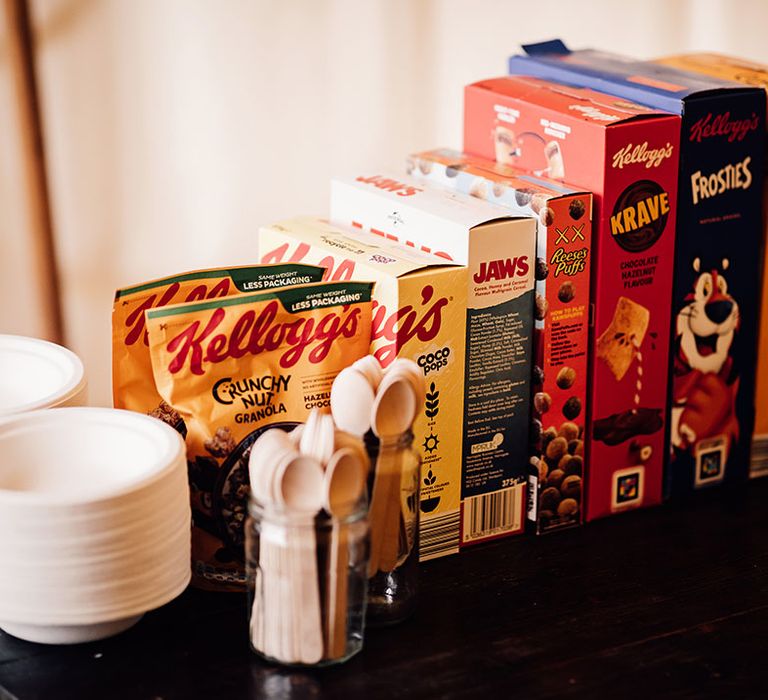 Cereal bar wedding station with classic kinds of cereal with wooden spoons and paper bowls