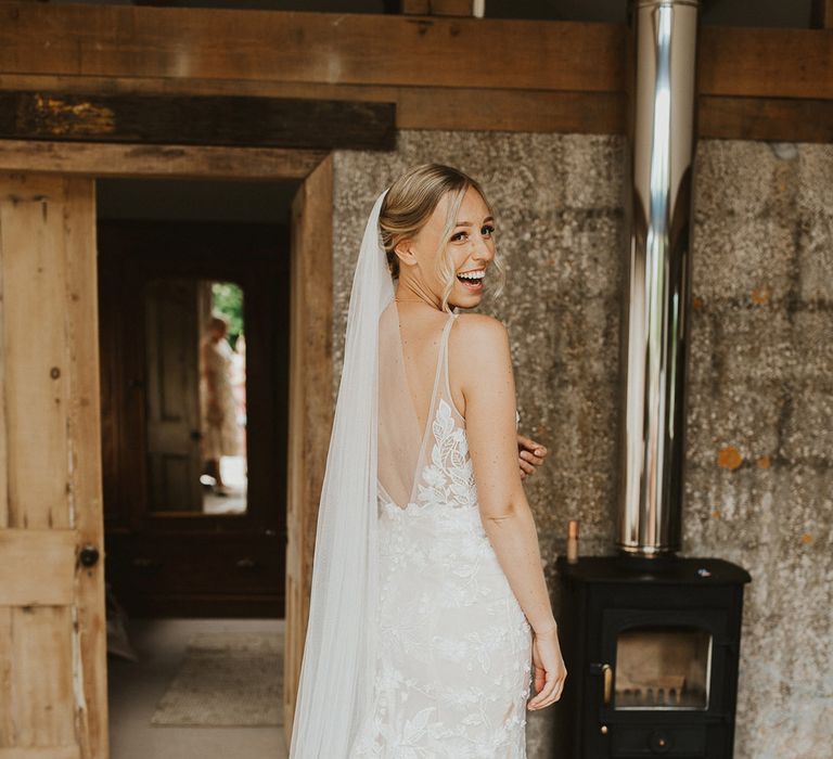 Bride in a low black lace wedding dress from Made With Love Bridal for her rustic style wedding day 