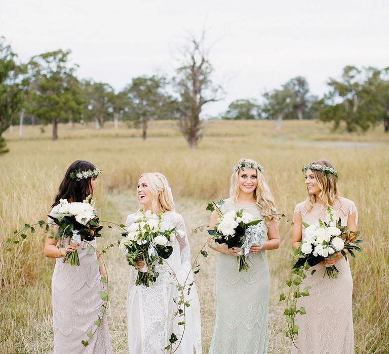 Bridesmaids in boho lace dresses with flower crowns for a boho wedding 