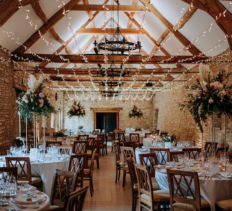 Caswell House wedding venue with twinkly fairly lights, champagne wedding floral arrangements and white tablescapes