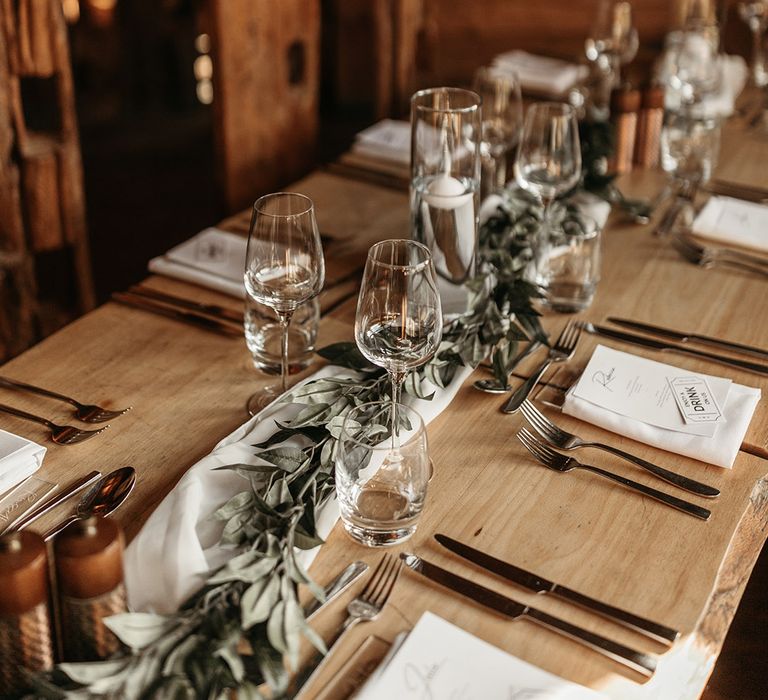 Rustic wedding at Alnwick Treehouse wedding venue with simple wedding table setting with foliage table runner 