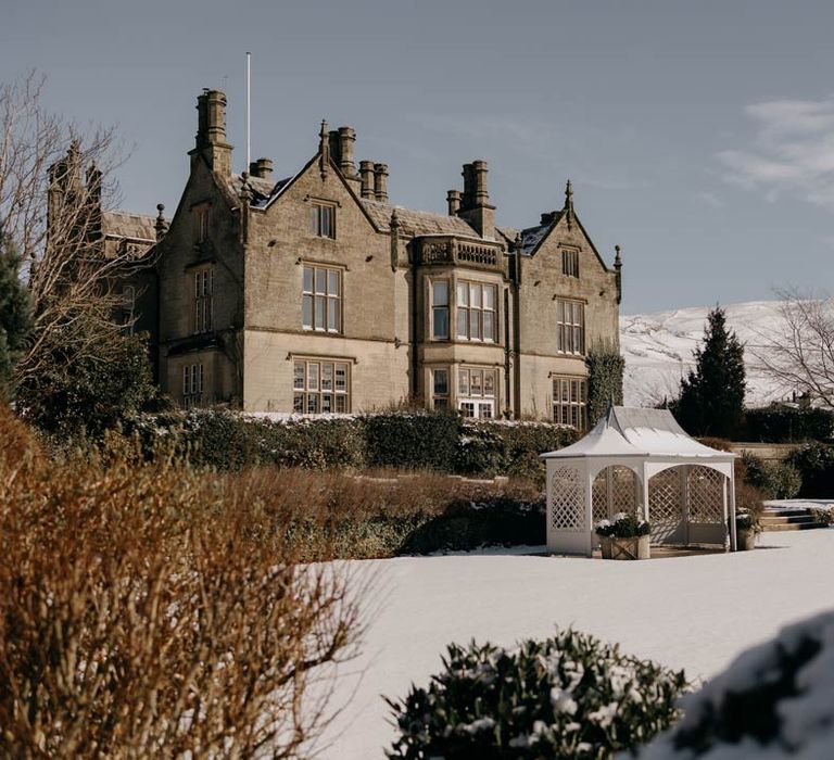 Falcon Manor house wedding venue in Yorkshire with snowy hills in the background 