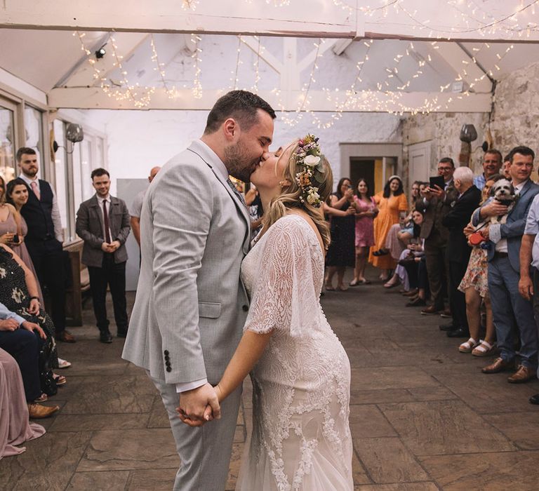 Boho wildflower wedding crown worn by bride for botanical wedding with the groom on the dance floor 