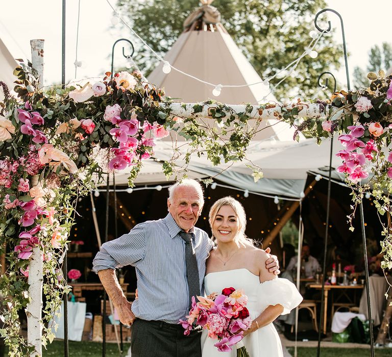 Bride and grandad pose together for special tipi wedding 