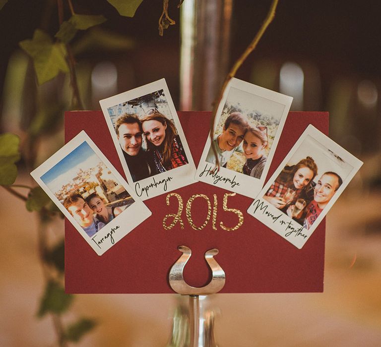 Burgundy wedding table name sign with polaroid photos 