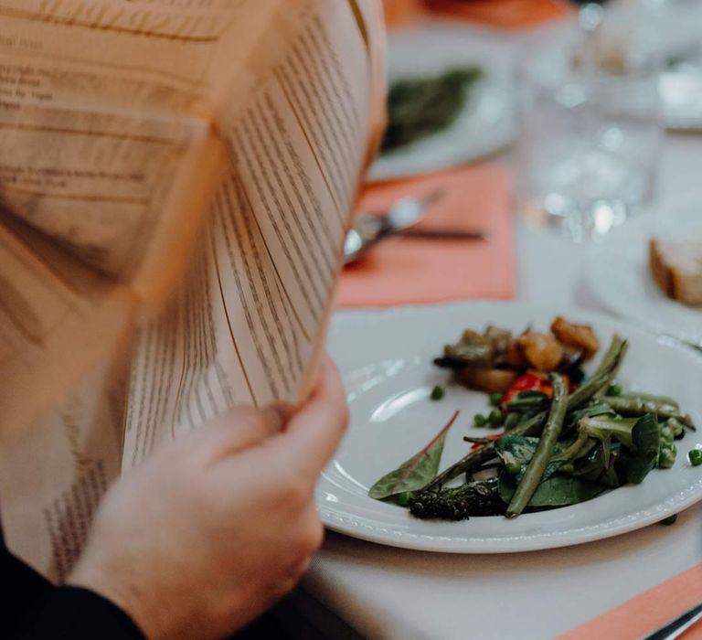 Newspaper wedding menu stationery at classic wedding tablescape with colourful wedding flower centrepieces