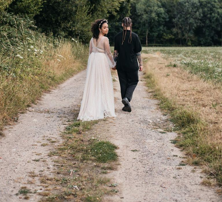 Brides walking around field at at-home Viking themed wedding