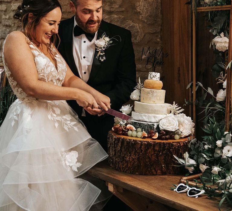 Cheese tower wedding cake on wooden tree slice