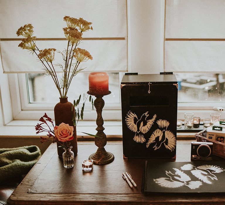 White bird print on the wedding guest book and card box on wooden table for guests 