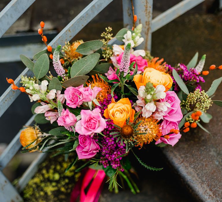 Pink and orange wedding bouquet with pink ribbon for bride 