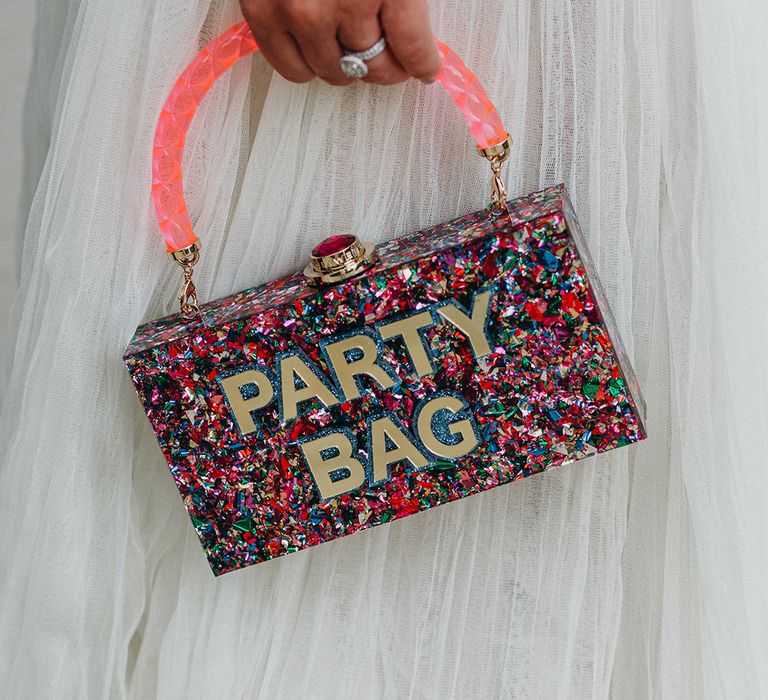 Colourful sparkly clutch bag with confetti style print and gemstone fastening for bride 