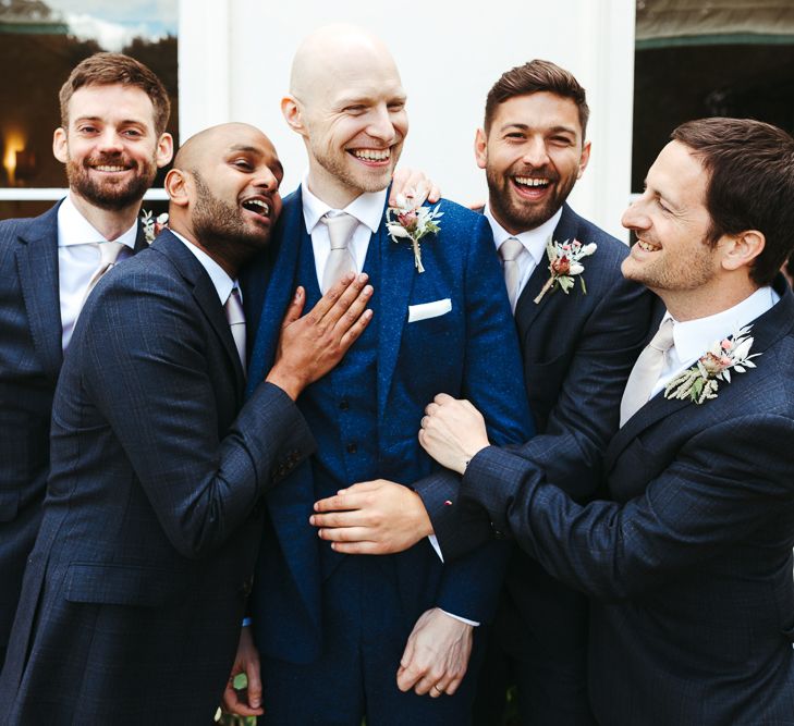 Groom and groomsmen in navy suits 