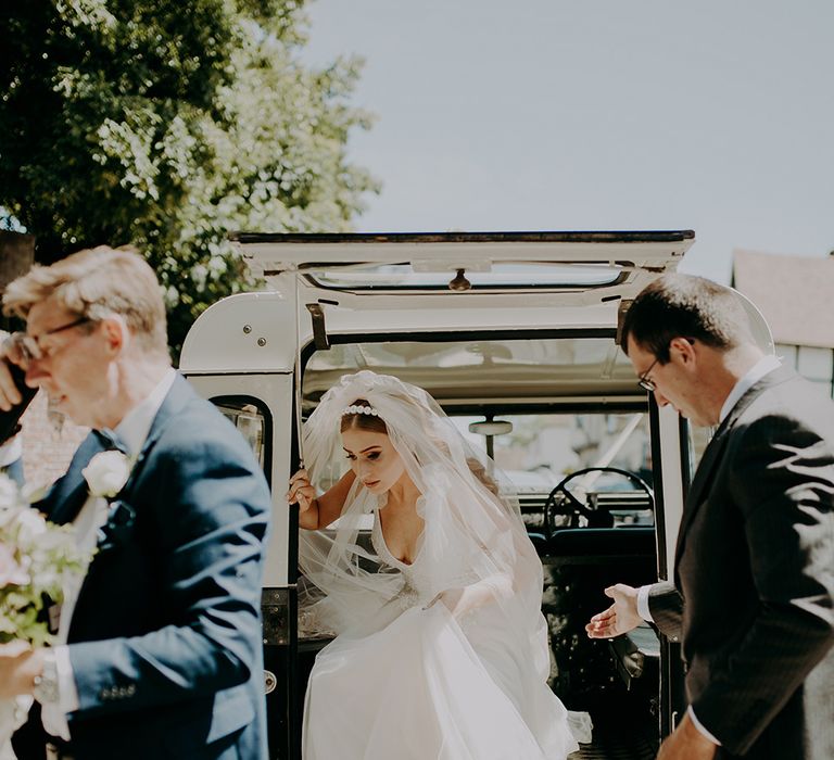 Bride arriving at the wedding in a jeep 