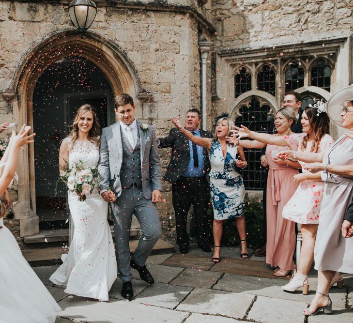 Bride and groom confetti exit 