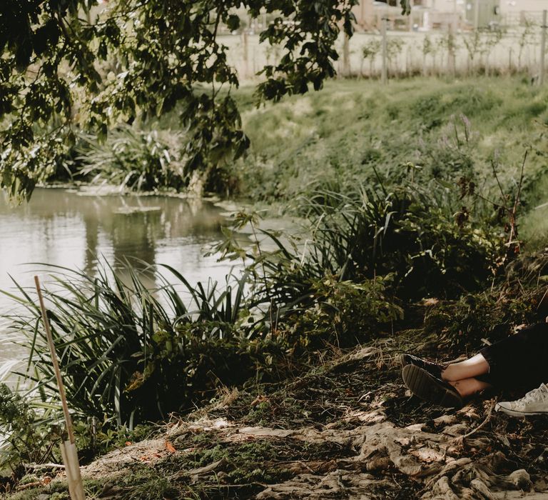 Bride in jumpsuit and trainers at 70s inspired wedding 