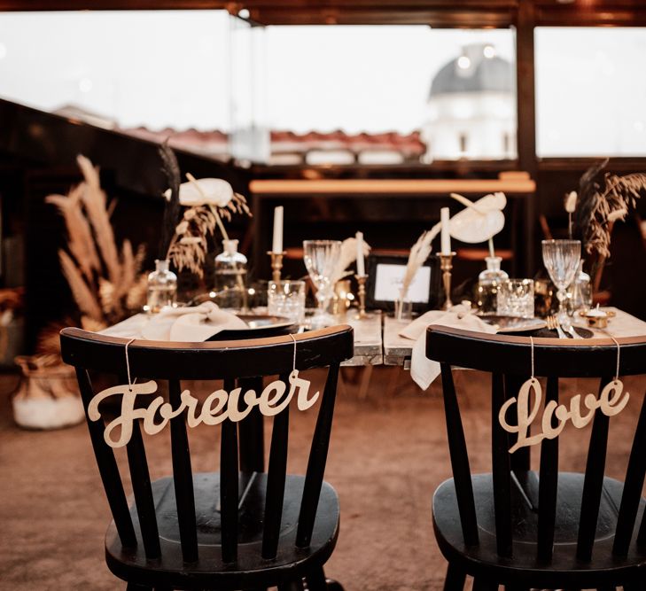 Black chairs with 'Forever Love' signs