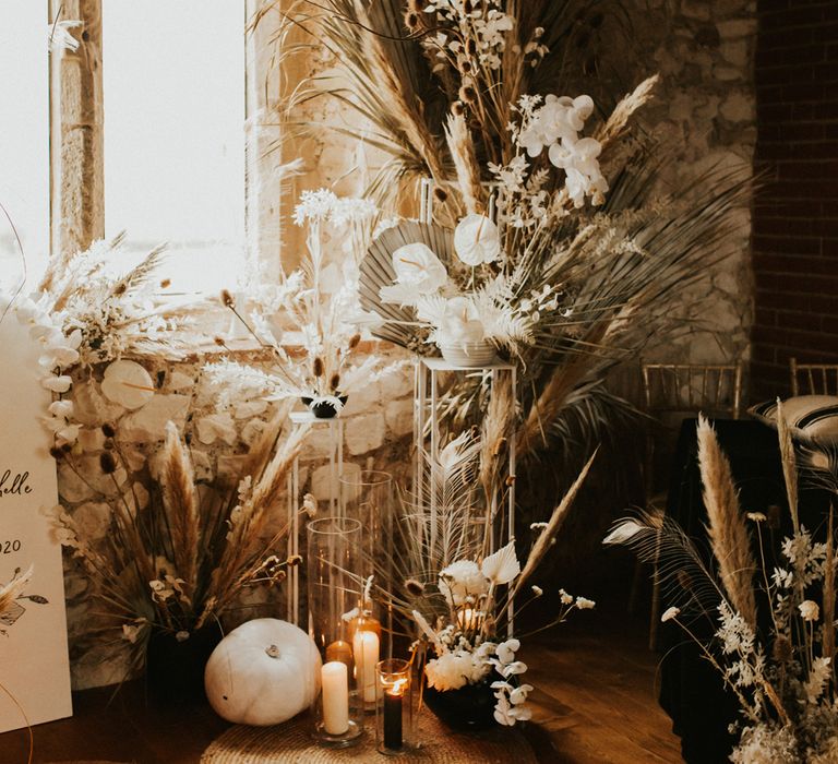 Autumn wedding decor with white pumpkin and pillar candles 