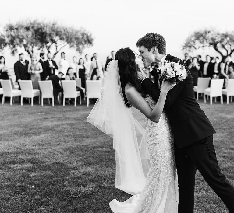 Black and white portrait of the bride and groom kissing by Miss Gen Photography