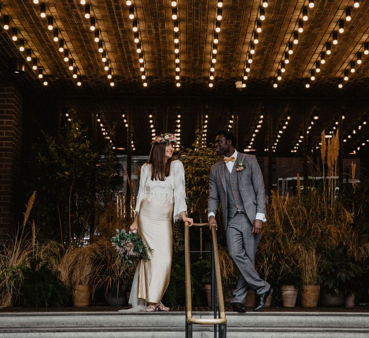 Couple stand either side of railings outside Shoreditch cinema