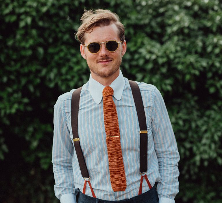 Groom in a sunglasses with striped shirt with white collar, braces and orange tie | Emily & Steve Photography